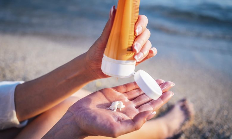 Woman using sunscreen